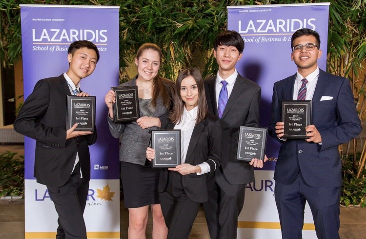 Cynthia and her
               team of student colleagues with their first place plaques